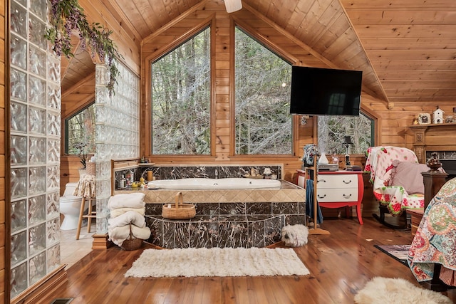 bathroom with hardwood / wood-style floors, a tub, wood ceiling, and toilet