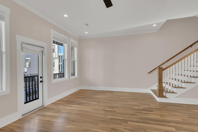 foyer entrance featuring crown molding and hardwood / wood-style floors