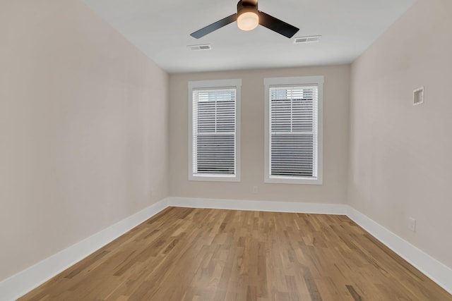 empty room featuring ceiling fan and light hardwood / wood-style flooring