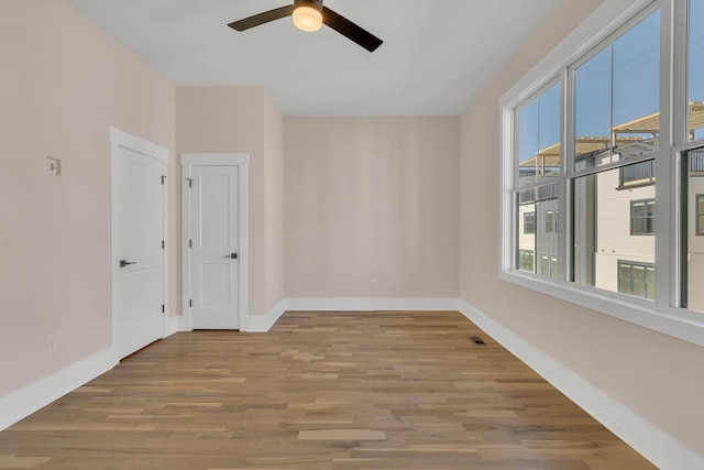 empty room with hardwood / wood-style flooring and ceiling fan