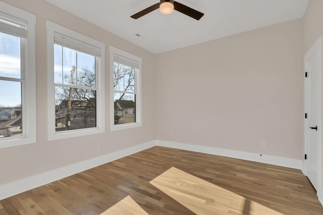 empty room featuring hardwood / wood-style floors and ceiling fan