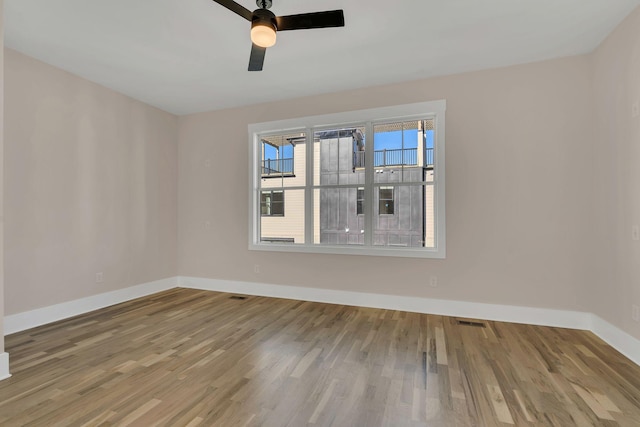 unfurnished room with hardwood / wood-style floors and ceiling fan