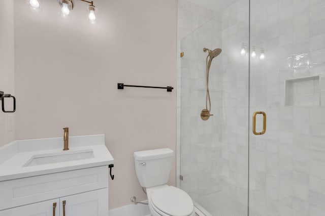 bathroom featuring walk in shower, vanity, and toilet