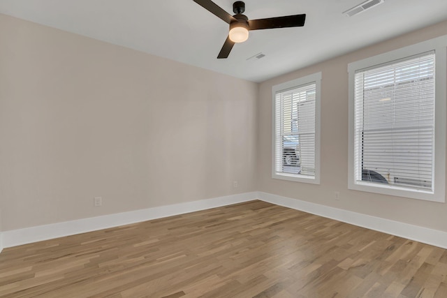 empty room with ceiling fan and light wood-type flooring