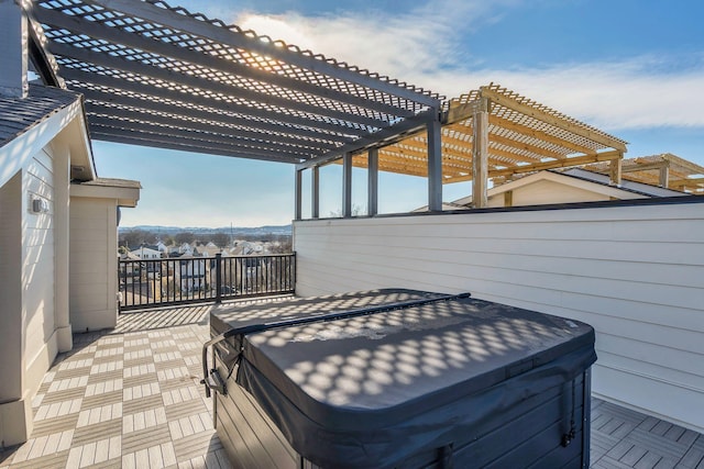 wooden deck with a pergola and a hot tub