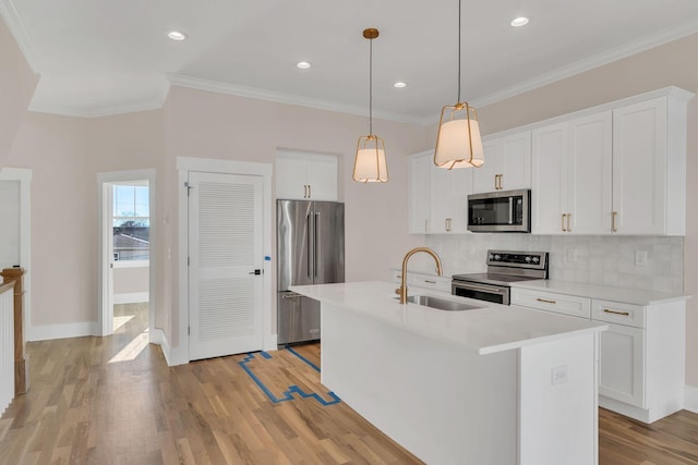 kitchen with white cabinetry, a center island with sink, stainless steel appliances, and sink