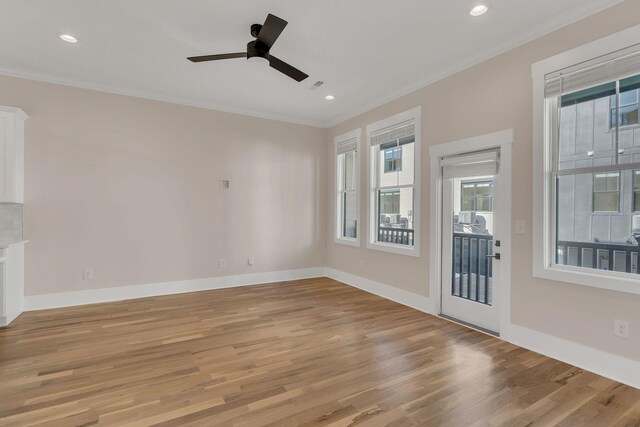 unfurnished living room with ceiling fan, crown molding, and light hardwood / wood-style flooring