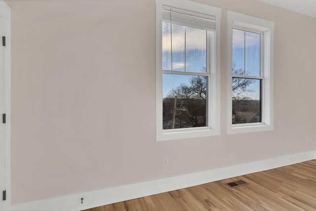 empty room with hardwood / wood-style flooring