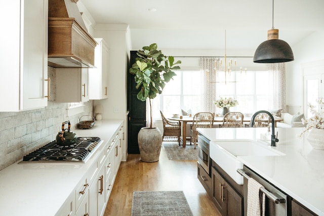 kitchen featuring appliances with stainless steel finishes, white cabinetry, and plenty of natural light