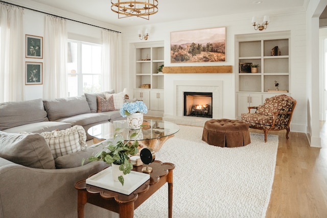 living room with ornamental molding, light hardwood / wood-style flooring, and a brick fireplace