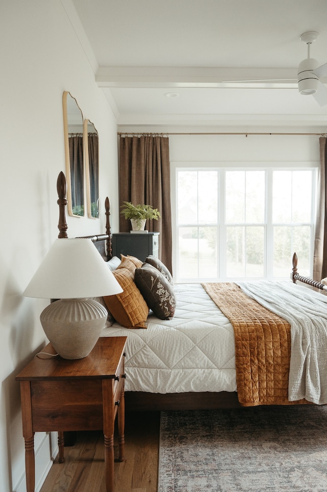 bedroom with crown molding, ceiling fan, multiple windows, and dark hardwood / wood-style flooring