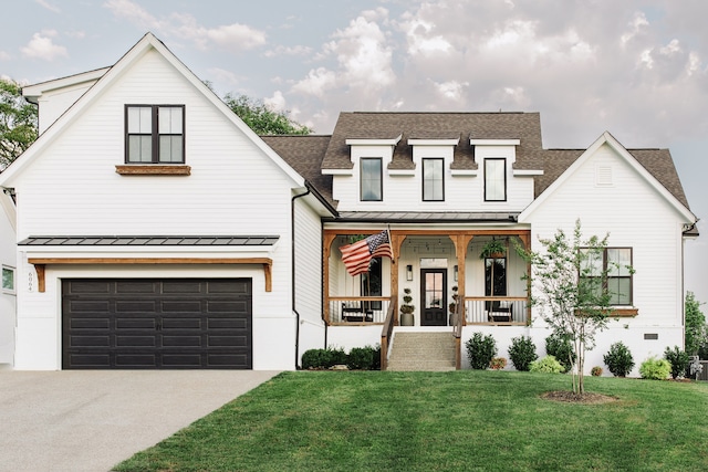 modern inspired farmhouse featuring covered porch, a front lawn, and a garage