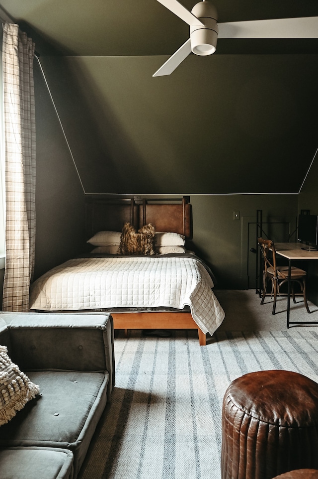 bedroom with vaulted ceiling, carpet flooring, and ceiling fan