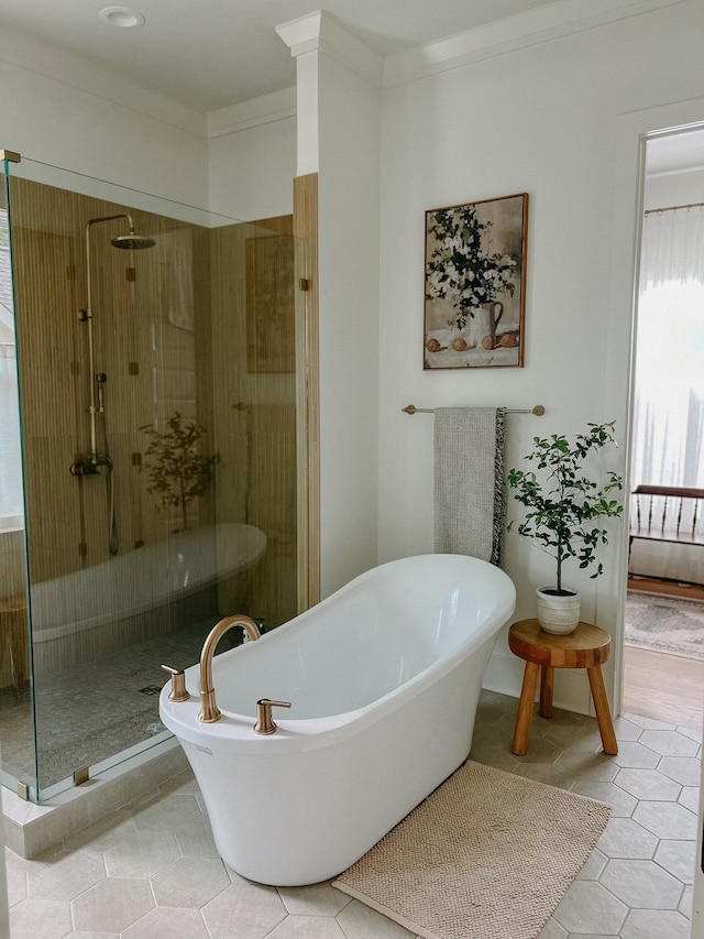 bathroom with independent shower and bath, ornamental molding, and tile patterned flooring