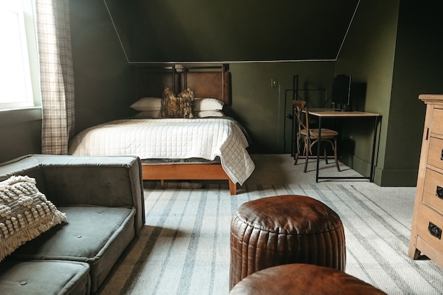 carpeted bedroom with vaulted ceiling