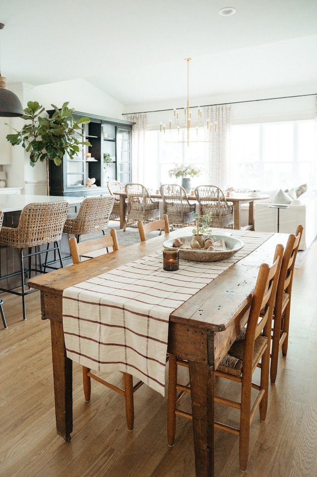 dining area with a chandelier and light wood-type flooring