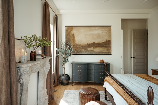 bedroom with crown molding and light wood-type flooring