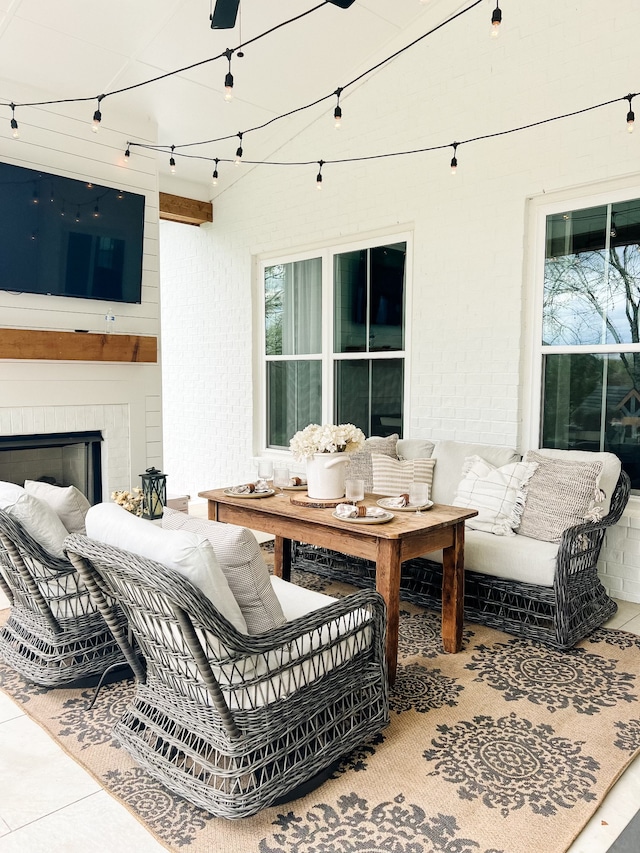 view of patio featuring a brick fireplace