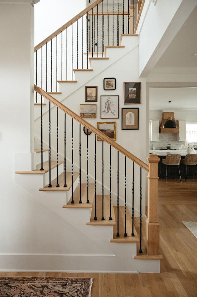 staircase with hardwood / wood-style floors