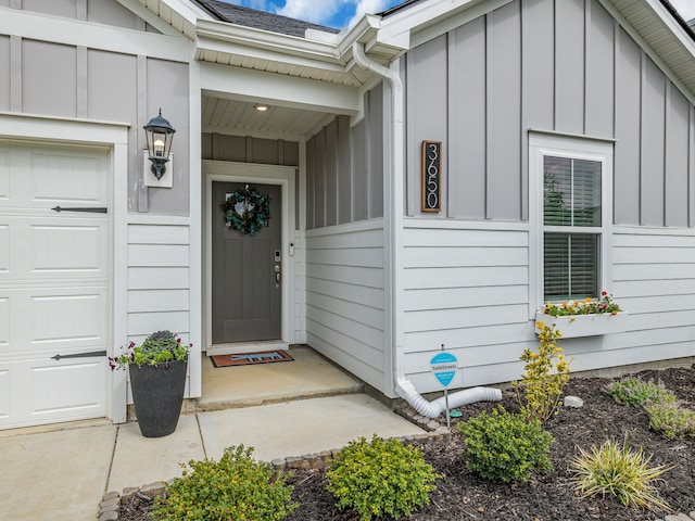 doorway to property with a garage