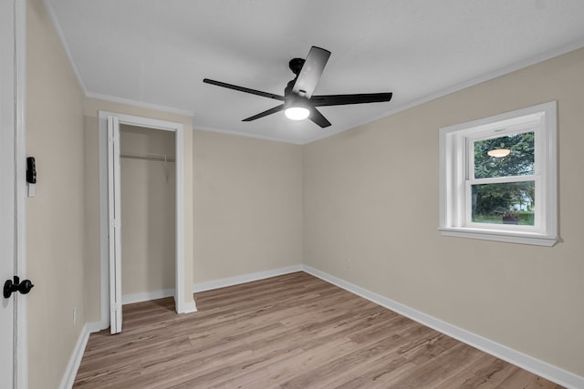 unfurnished bedroom featuring ceiling fan, ornamental molding, and light wood-type flooring