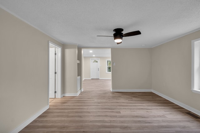 unfurnished room featuring light hardwood / wood-style flooring, a textured ceiling, and ceiling fan