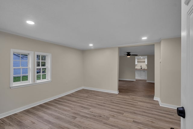 spare room with light hardwood / wood-style floors and ceiling fan