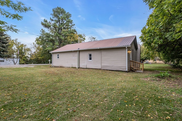 view of side of home featuring a yard