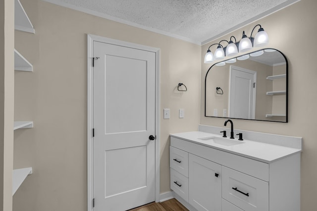 bathroom with vanity, a textured ceiling, and hardwood / wood-style flooring