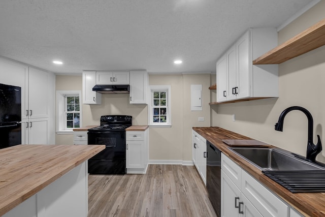 kitchen featuring wood counters, white cabinets, and black appliances