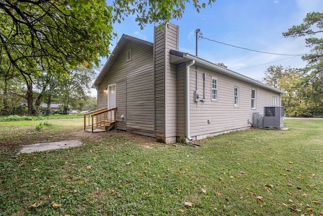 view of side of home with a lawn