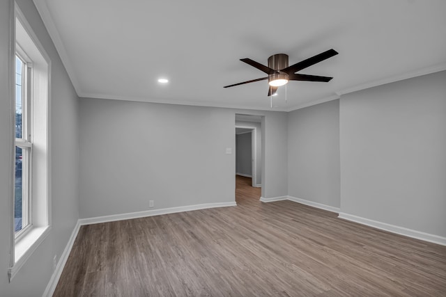 unfurnished room featuring ceiling fan, ornamental molding, and light hardwood / wood-style flooring