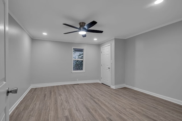 empty room with light hardwood / wood-style flooring, ceiling fan, and crown molding