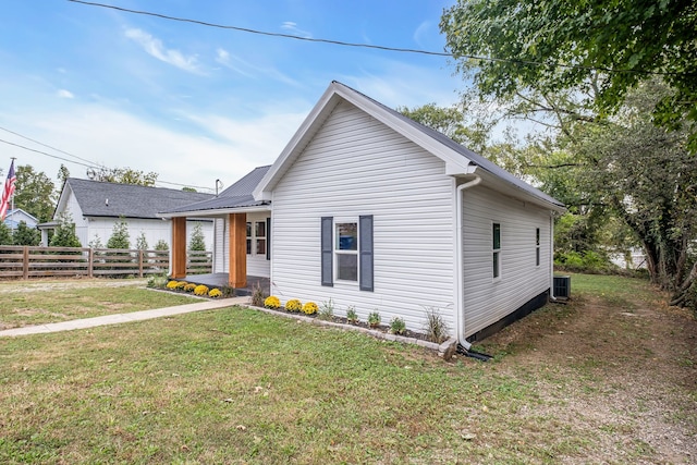 view of front of property with cooling unit and a front yard