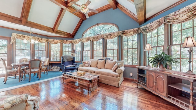 sunroom / solarium with a wealth of natural light, vaulted ceiling with beams, and ceiling fan with notable chandelier