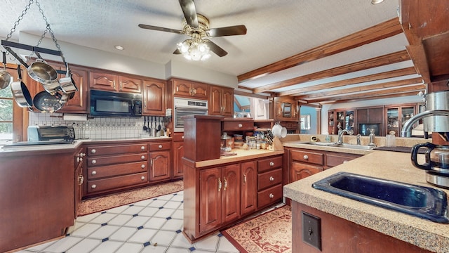 kitchen with a textured ceiling, black appliances, sink, and ceiling fan