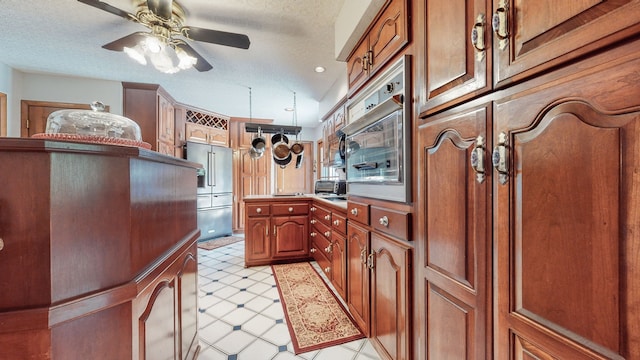 kitchen with high quality fridge, a textured ceiling, light tile patterned floors, and ceiling fan