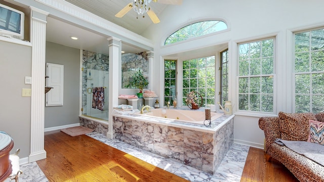 sunroom / solarium with vaulted ceiling, ornate columns, and ceiling fan