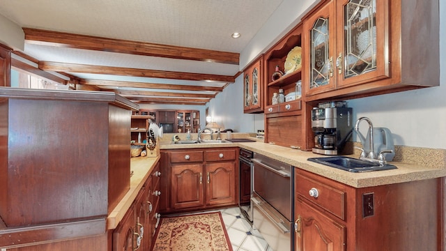 kitchen with sink, beam ceiling, light tile patterned floors, and kitchen peninsula