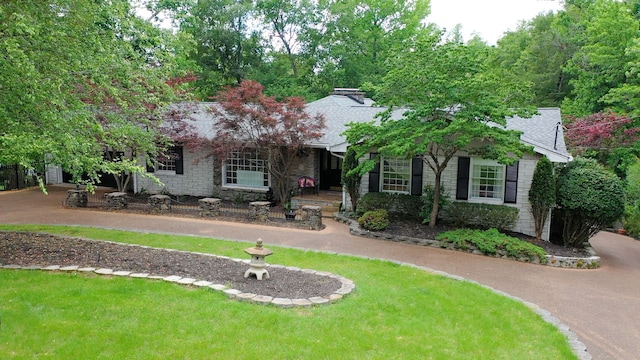 obstructed view of property with a front yard