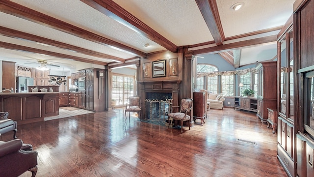 living room featuring light hardwood / wood-style floors, a textured ceiling, and ceiling fan