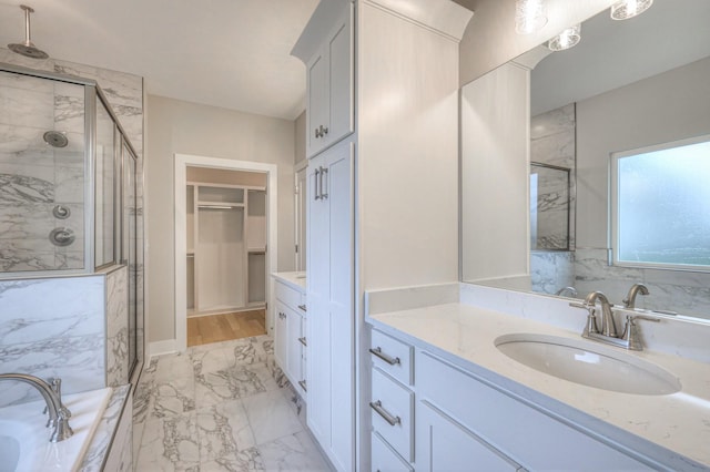 bathroom featuring independent shower and bath and vanity