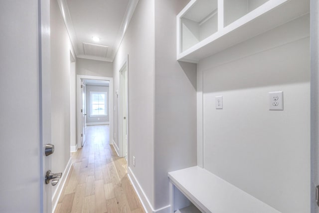 hallway featuring crown molding and light wood-type flooring