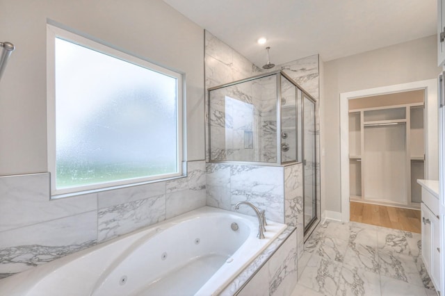 bathroom with vanity and independent shower and bath