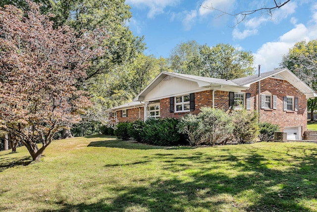 view of property exterior with a yard, central air condition unit, and a garage