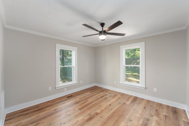 spare room featuring ceiling fan, a healthy amount of sunlight, and light hardwood / wood-style flooring