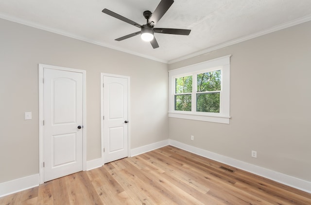 unfurnished bedroom with ceiling fan, crown molding, and light hardwood / wood-style floors