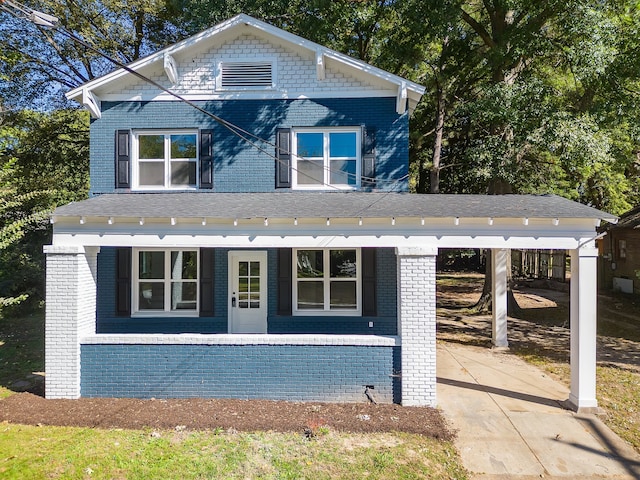 view of front of home featuring covered porch and a carport