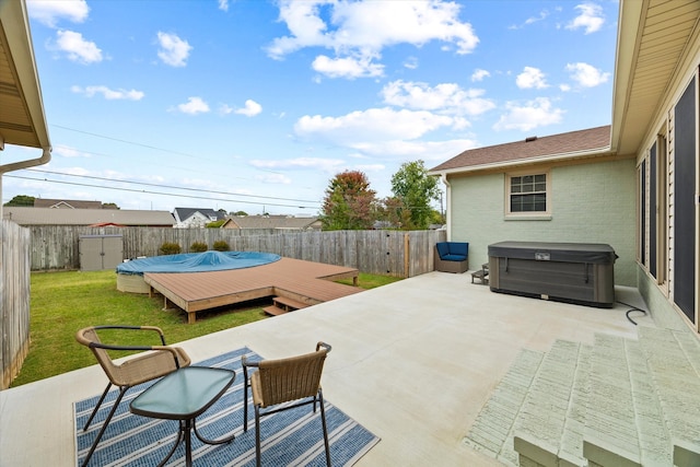 view of patio featuring a wooden deck and a hot tub