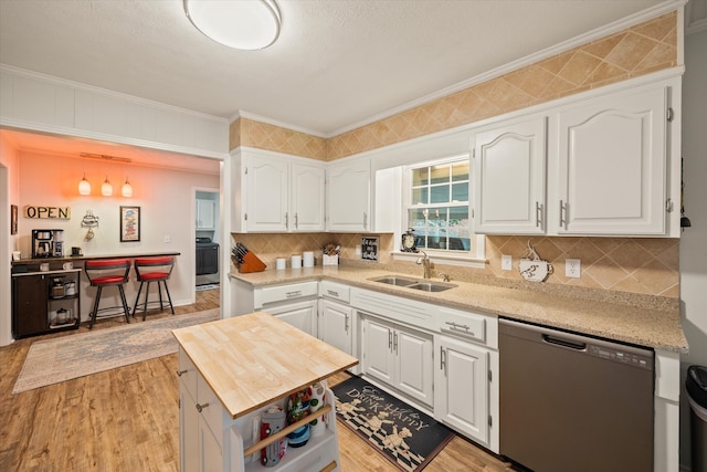 kitchen with appliances with stainless steel finishes, white cabinets, and light wood-type flooring